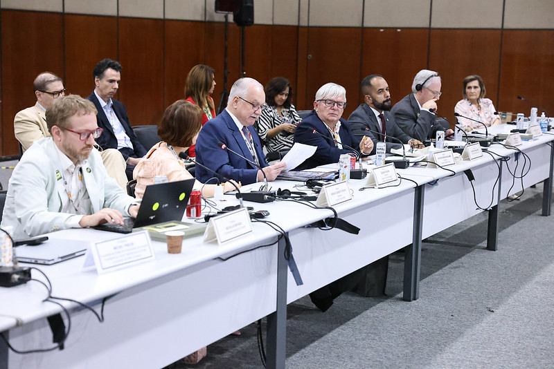 MInistro Fachin lendo o discurso na mesa do evento.