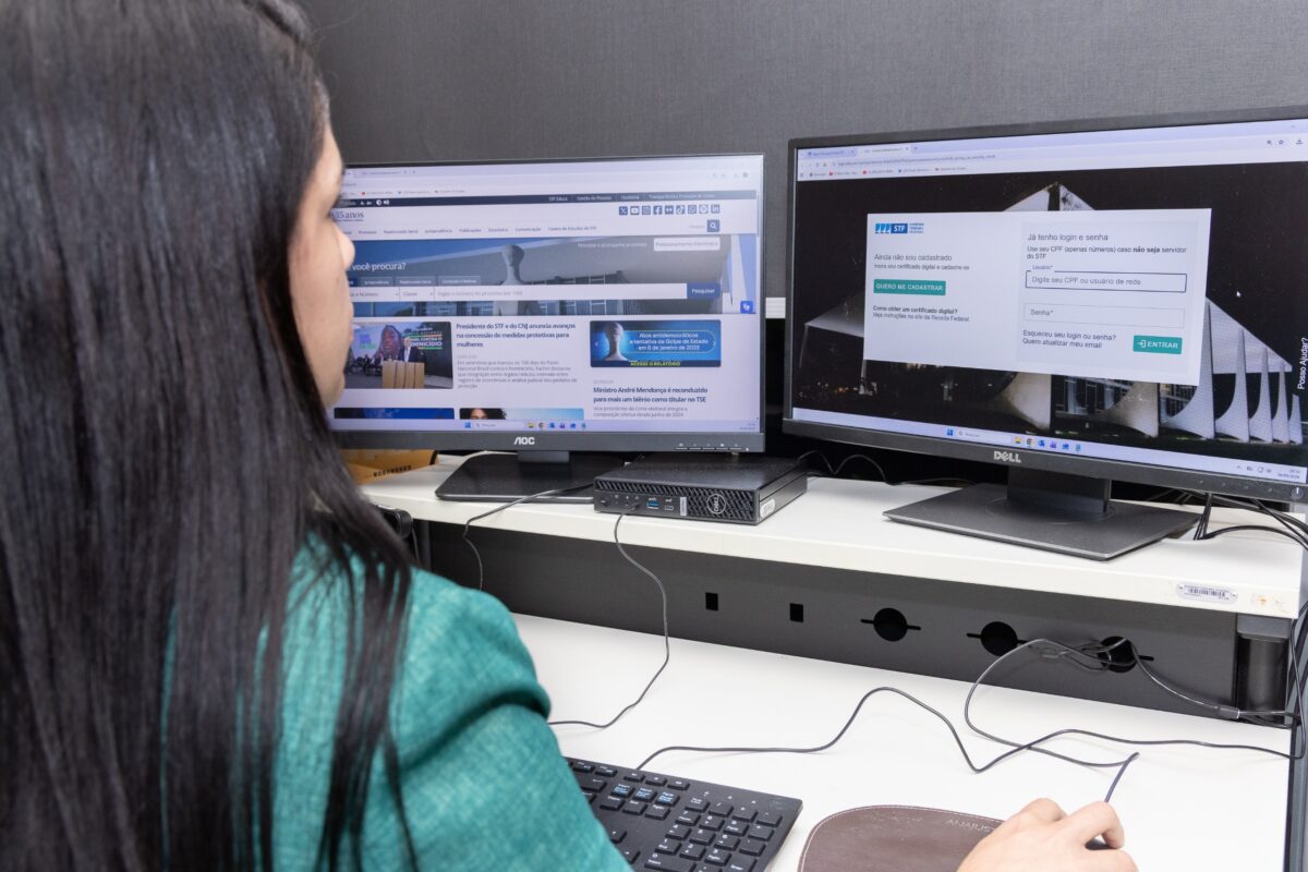 Fotografia de uma mulher acessando sistemas do STF pela tela de um computador.