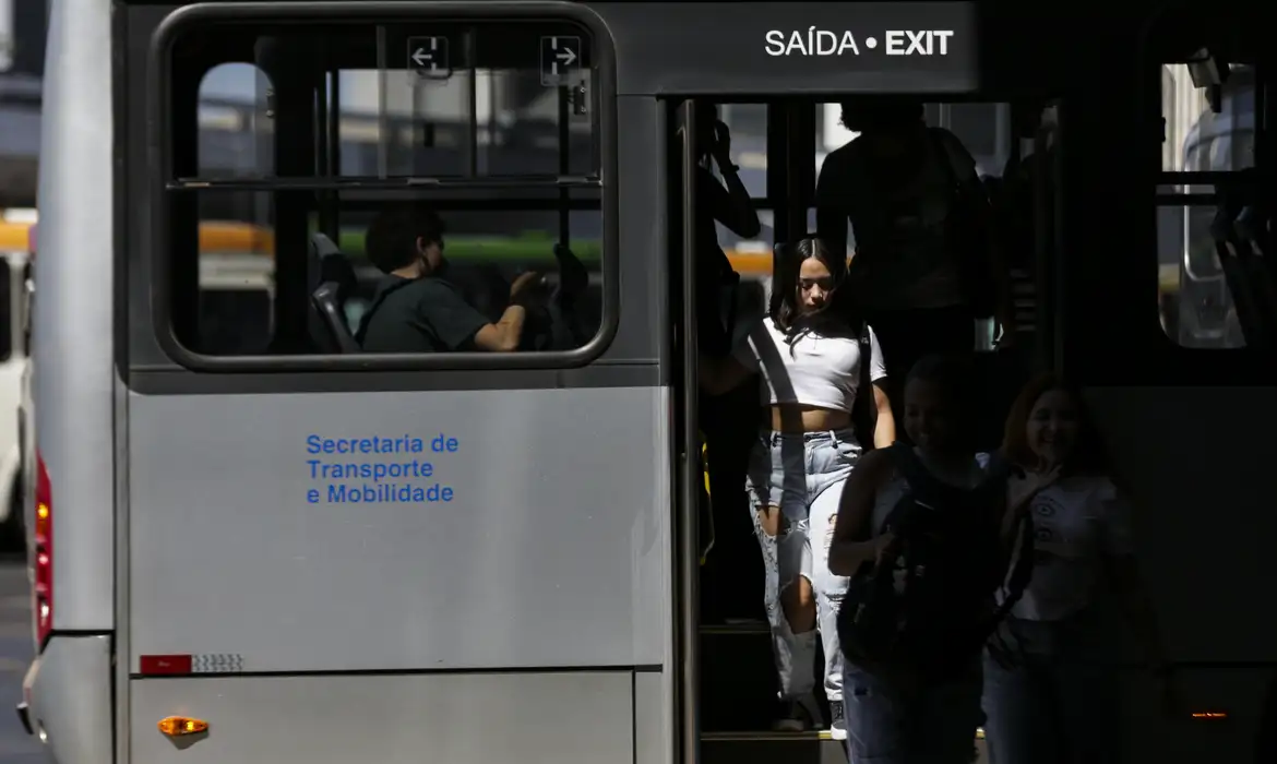 Pessoas saltando de ônibus